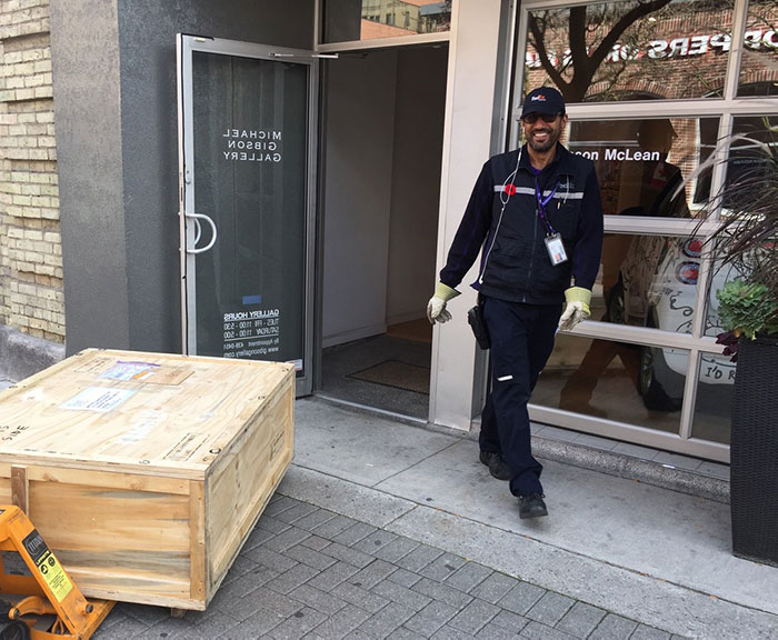 Delivery man moving crate