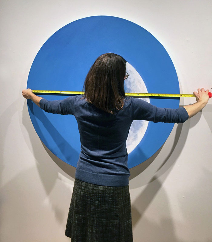 Woman measuring an art piece